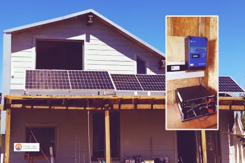 Paneles fotovoltaicos sobre el techo de una casa, con el inversor y las baterías en el recuadro
