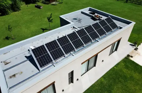 Vista aérea de paneles solares en el techo plano de una casa moderna